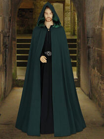 Man long green hooded robe in castle hallway