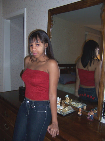 Danielle age 13 leaning against dresser