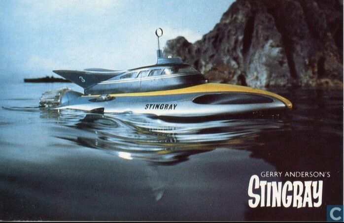 Stingray the futuristic submarine next to rocky formation