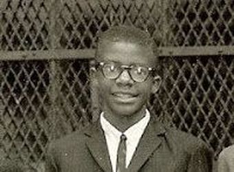 Lloyd age 12 with black glasses and suit