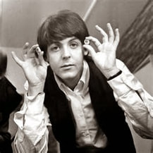 Paul McCartney holding two fake eyeballs