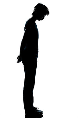 Silhouette of young man with head down