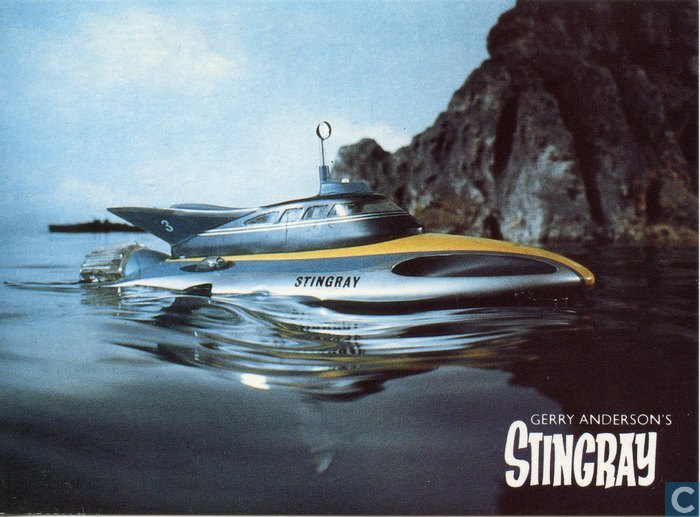 Stingray the futuristic submarine next to rocky formation