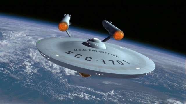 Taking off. The starship Enterprise hovering over Earth.jpg